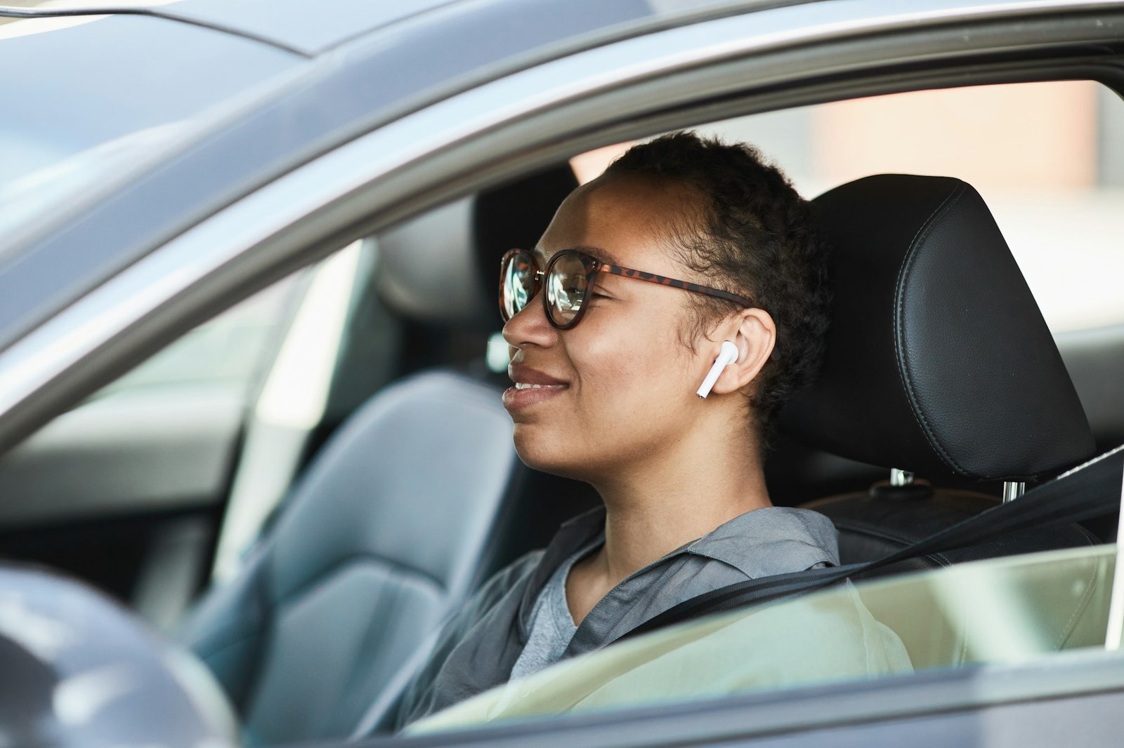 African woman driving by car